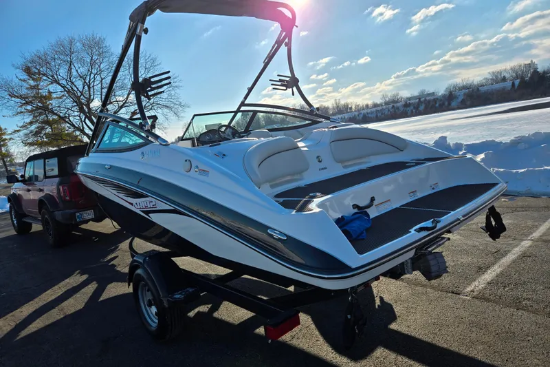 Slide: The Image of 2014 Yamaha AR192 boat on trailer in sunny, snowy landscape. - 1