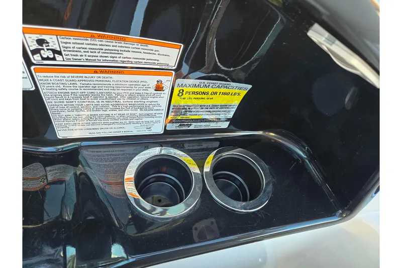 Slide: The Image of 2014 Yamaha Boats AR192 dashboard with warning labels and cup holders. - 12