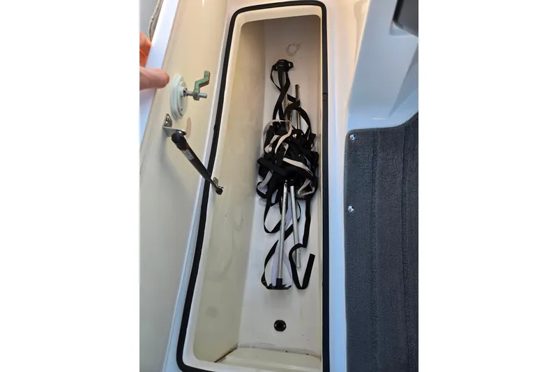 Slide: The Image of 2014 Yamaha AR192 boat storage compartment with straps and latch mechanism. - 13