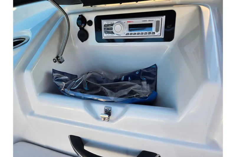 Slide: The Image of 2014 Yamaha AR192 boat dashboard with stereo system and storage compartment. - 14