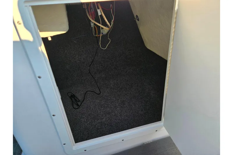 Slide: The Image of Interior storage compartment of 2014 Yamaha Boats AR192 with visible wiring. - 15