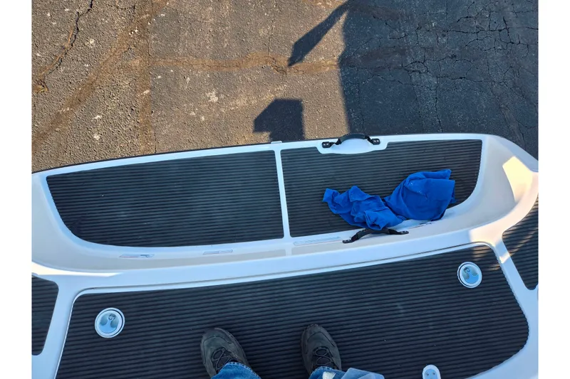 Slide: The Image of 2014 Yamaha Boats AR192 swim platform with blue towel and textured surface. - 22