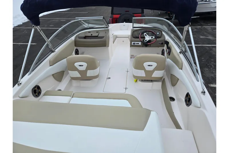 Slide: The Image of 2015 Regal 1900 ES Bowrider interior with beige seating and steering wheel. - 10