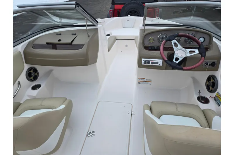 Slide: The Image of 2015 Regal 1900 ES Bowrider interior with beige seating and steering wheel. - 11