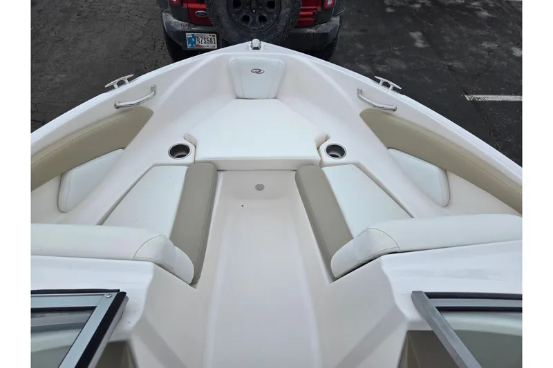 Slide: The Image of 2015 Regal 1900 ES Bowrider boat interior with beige and white seating. - 16