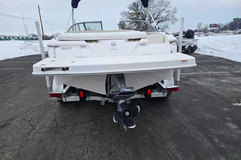 Slide: The Image of 2015 Regal 1900 ES Bowrider boat on trailer, rear view in snowy parking lot. - 2