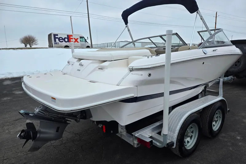 Slide: The Image of 2015 Regal 1900 ES Bowrider on trailer, parked outdoors with FedEx truck in background. - 3