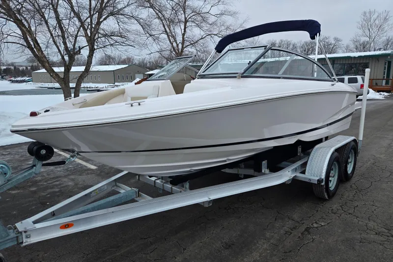 Slide: The Image of 2015 Regal 1900 ES Bowrider on trailer, parked in snowy outdoor setting. - 8