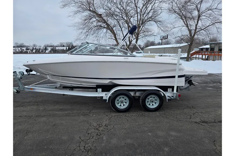 Slide: The Image of 2015 Regal 1900 ES Bowrider on trailer, parked in snowy outdoor setting. - 9