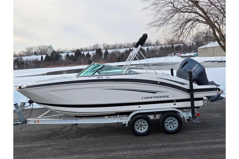 The Image of 2016 Chaparral 210 Suncoast Ski & Fish boat on trailer by snowy lakeside. - 0