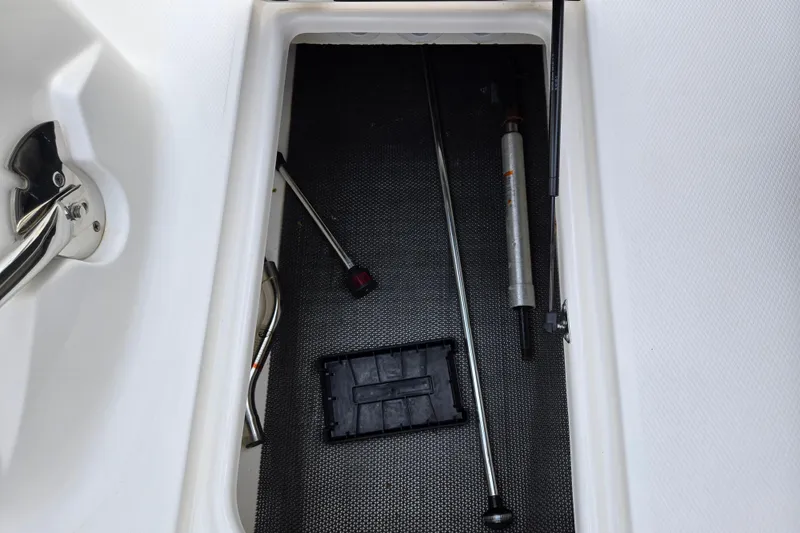 Slide: The Image of Storage compartment with tools in a 2016 Chaparral 210 Suncoast Ski & Fish boat. - 12
