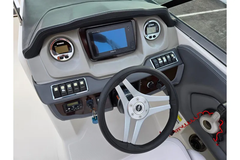 Slide: The Image of Dashboard of 2016 Chaparral 210 Suncoast Ski & Fish boat with steering wheel and controls. - 13
