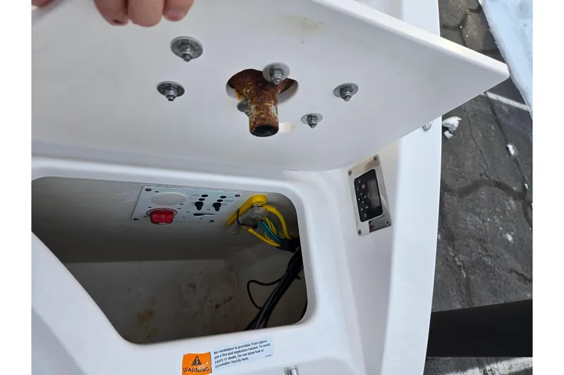 Slide: The Image of Open compartment of 2016 Chaparral 210 Suncoast Ski & Fish boat showing wiring and controls. - 27