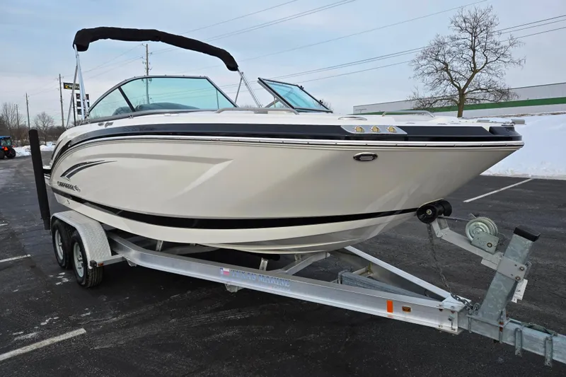Slide: The Image of 2016 Chaparral 210 Suncoast Ski & Fish boat on trailer in parking lot. - 5