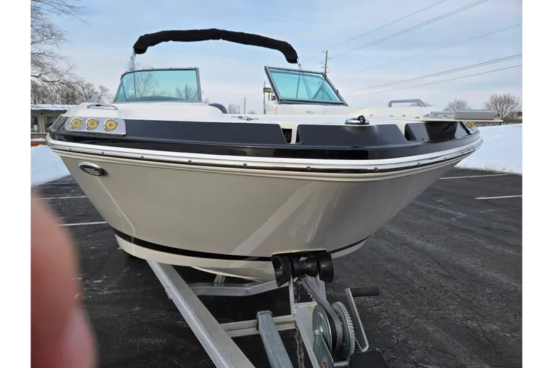 Slide: The Image of 2016 Chaparral 210 Suncoast Ski & Fish boat on trailer, parked in snowy lot. - 6