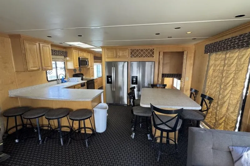 Slide: The Image of Modern kitchen interior on American Waterways Desert Rain Trip, featuring bar stools and stainless steel appliances. - 17