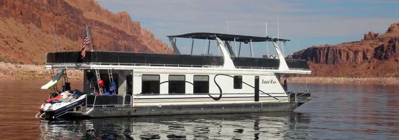 The Image of Houseboat on calm water with red rock backdrop, 2006. - 2