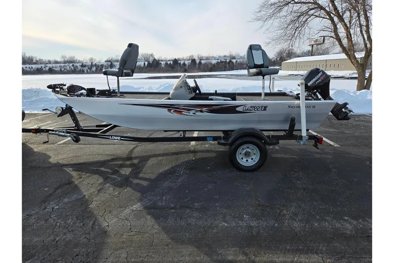 Slide: The Image of 2016 Lowe Skorpion boat on trailer, parked on snowy lakeside pavement. - 10