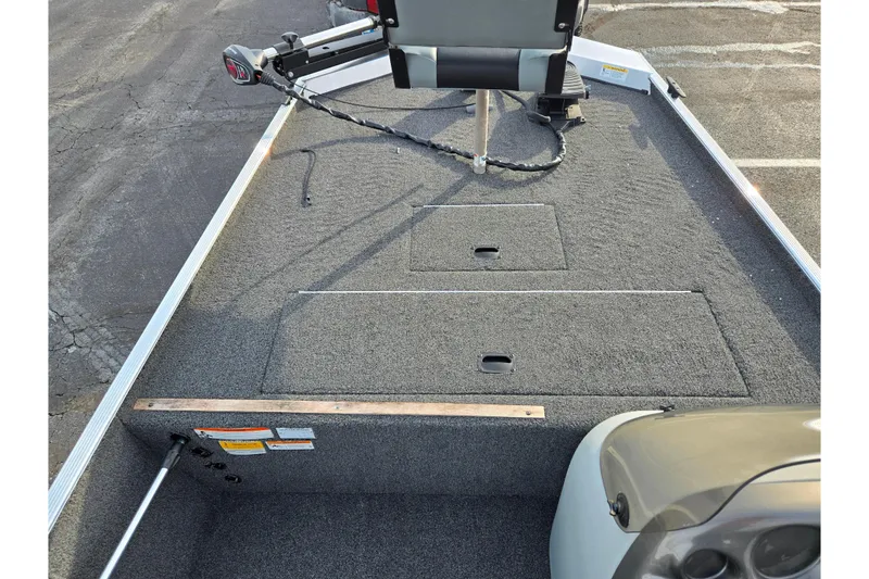 Slide: The Image of 2016 Lowe Skorpion boat interior with carpeted deck and seating. - 13