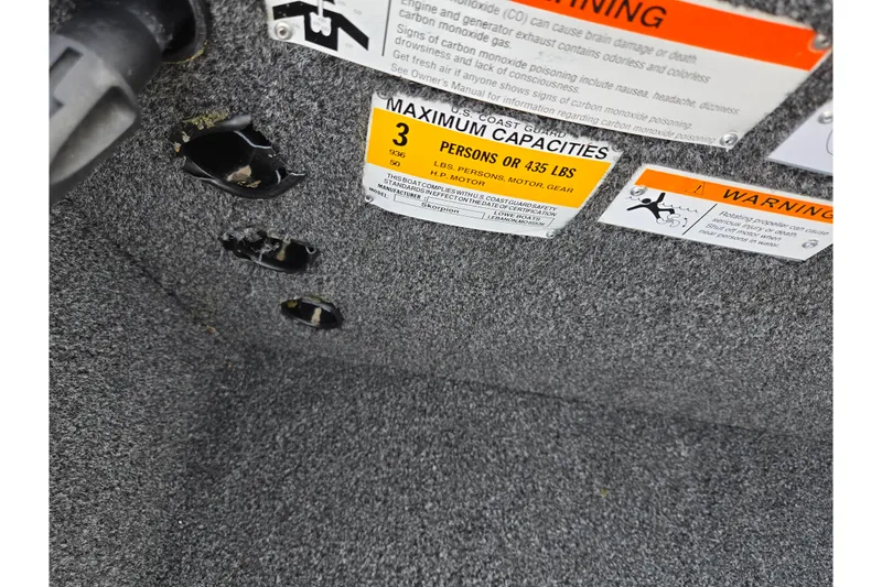 Slide: The Image of 2016 Lowe Skorpion boat warning labels and maximum capacity information. - 14