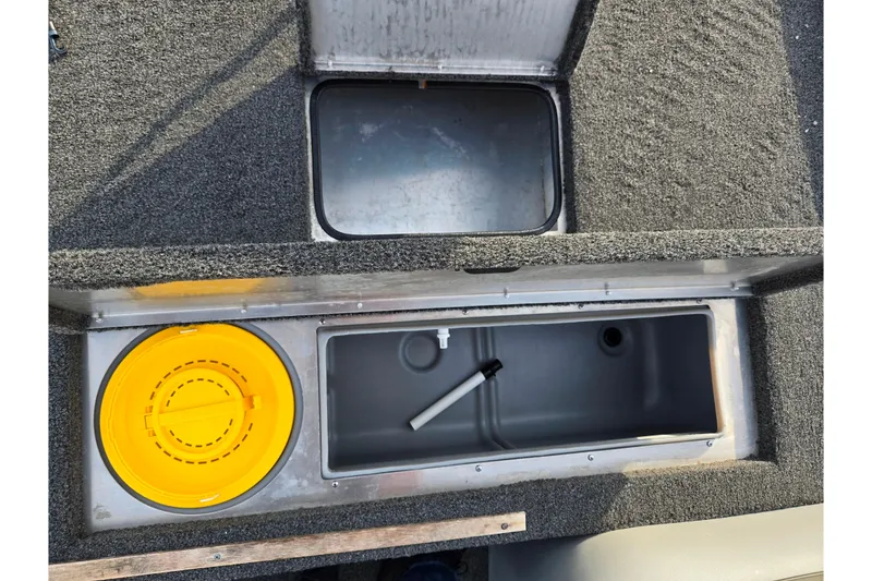 Slide: The Image of 2016 Lowe Skorpion boat storage compartments with yellow lid and gray interior. - 15