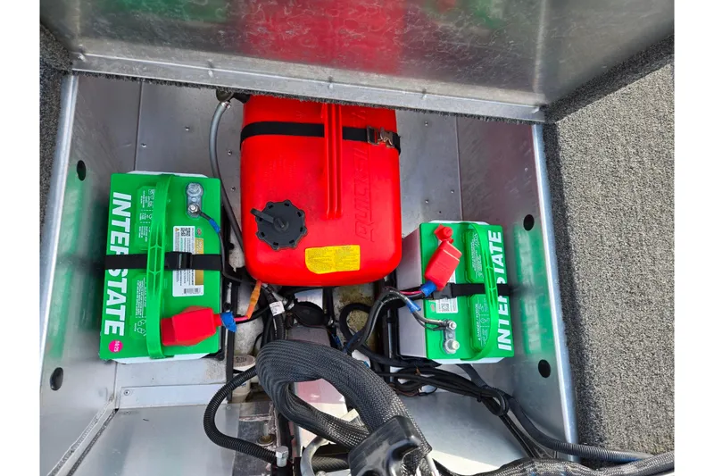 Slide: The Image of 2016 Lowe Skorpion boat battery compartment with Interstate batteries and red fuel tank. - 23