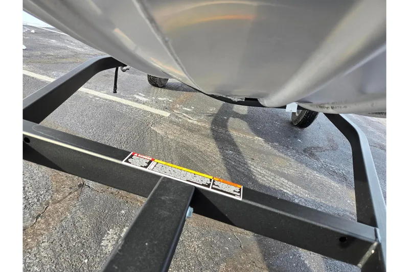 Slide: The Image of 2016 Lowe Skorpion boat trailer frame on asphalt surface. - 7
