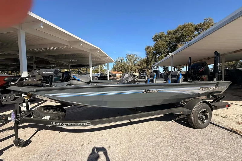 The Image of 2026 Ranger RT188P fishing boat on trailer under sunny sky. - 0