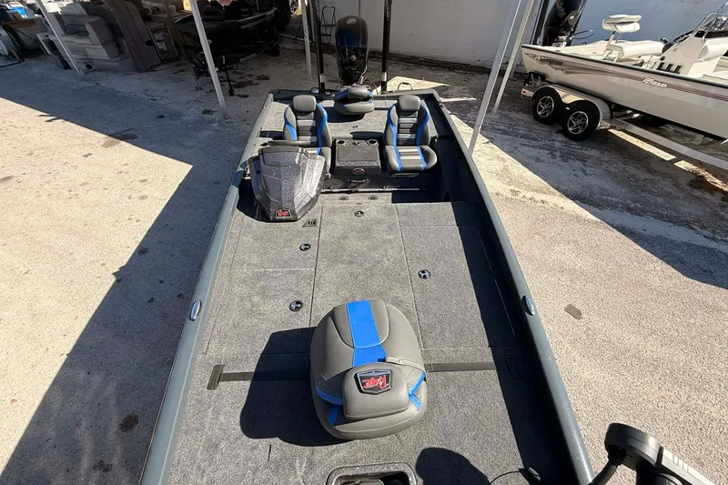 Slide: The Image of 2026 Ranger RT188P fishing boat with blue and gray seating, parked outdoors. - 5