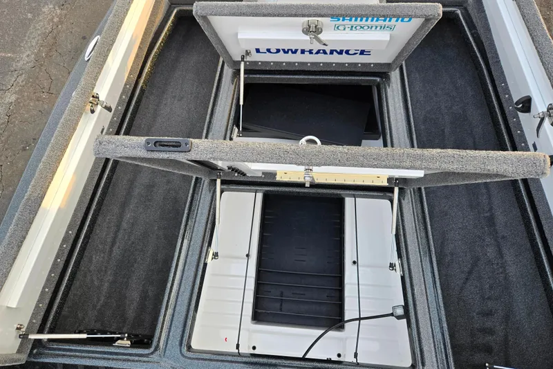 Slide: The Image of 2016 Phoenix 721 ProXP boat storage compartments with Lowrance and Shimano branding. - 15
