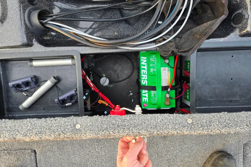 Slide: The Image of 2016 Phoenix 721 ProXP boat battery compartment with Interstate battery and wiring. - 23