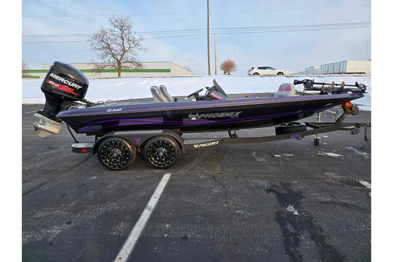 Slide: The Image of 2016 Phoenix 721 ProXP bass boat with Mercury engine, parked on snowy pavement. - 4