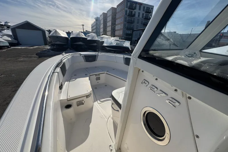 Slide: The Image of 2020 Robalo R272 Center Console boat docked, showcasing spacious interior and modern design. - 5