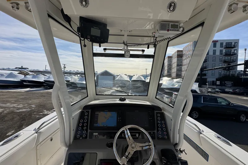 Slide: The Image of 2020 Robalo R272 Center Console boat interior with navigation system and steering wheel. - 7