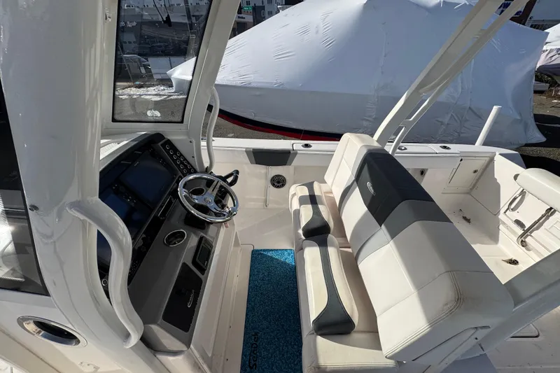 Slide: The Image of 2020 Robalo R272 Center Console boat interior with steering wheel and seating. - 8