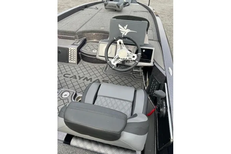 Slide: The Image of 2026 Caymas CX 21 PRO boat interior with steering wheel and seating. - 3