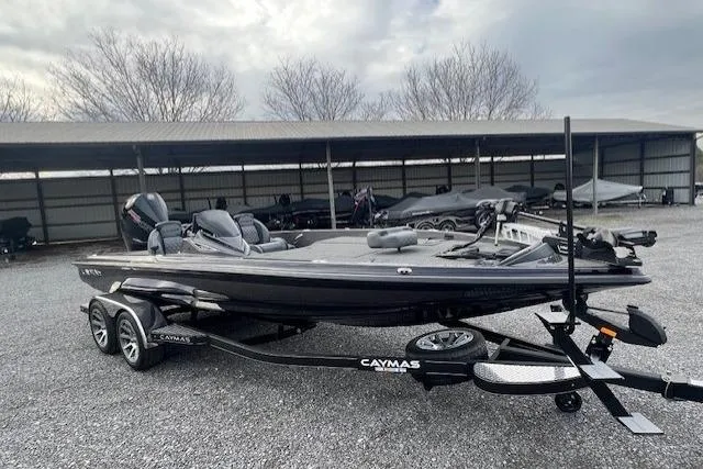Slide: The Image of 2026 Caymas CX 21 PRO bass boat on trailer, parked outdoors under cloudy sky. - 5