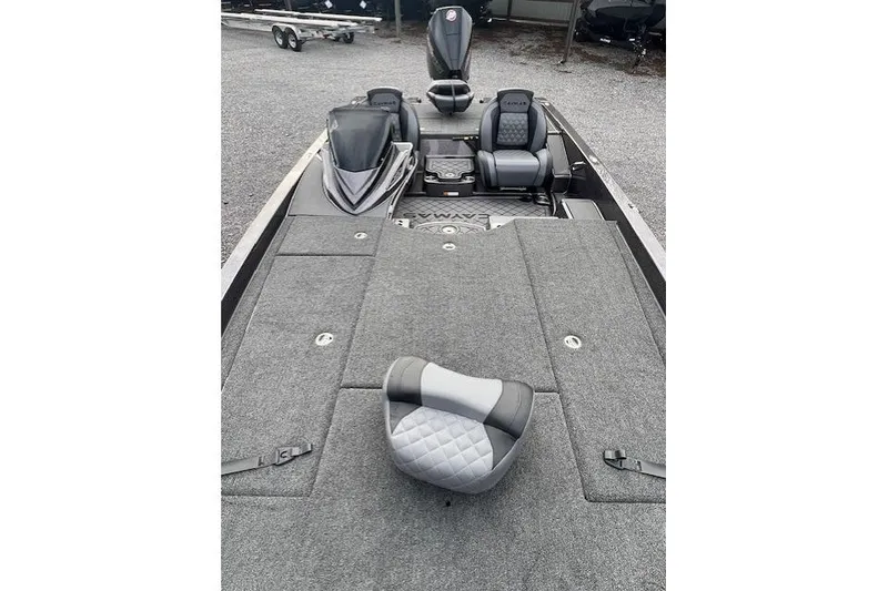 Slide: The Image of 2026 Caymas CX 21 PRO boat interior with gray seating and carpeted deck. - 7