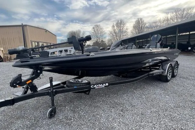 Slide: The Image of 2026 Caymas CX 21 PRO boat on trailer, parked outdoors under cloudy sky. - 8