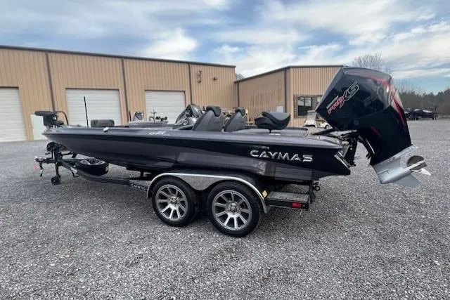 Slide: The Image of 2026 Caymas CX 21 PRO boat on trailer, parked outside industrial building. - 9
