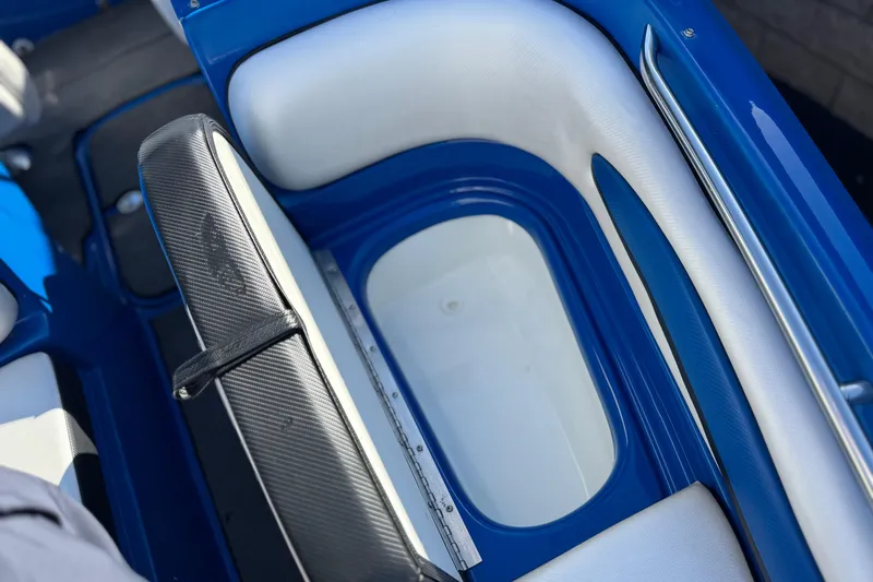 Slide: The Image of Interior of 2015 Caravelle 22 Interceptor boat, featuring blue and white seating. - 14