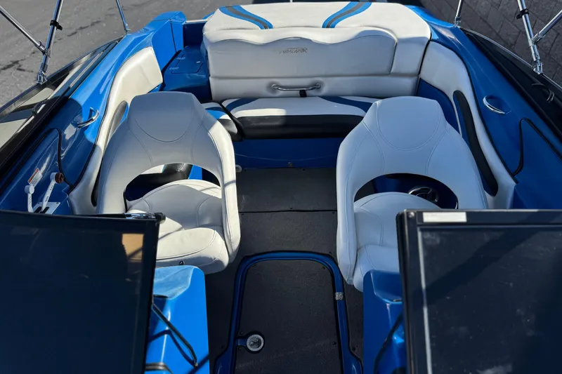 Slide: The Image of Interior of a 2015 Caravelle 22 Interceptor boat with blue and white seating. - 15