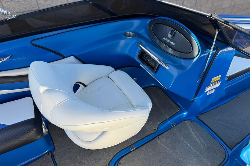 Slide: The Image of 2015 Caravelle 22 Interceptor boat interior with white seating and blue accents. - 20