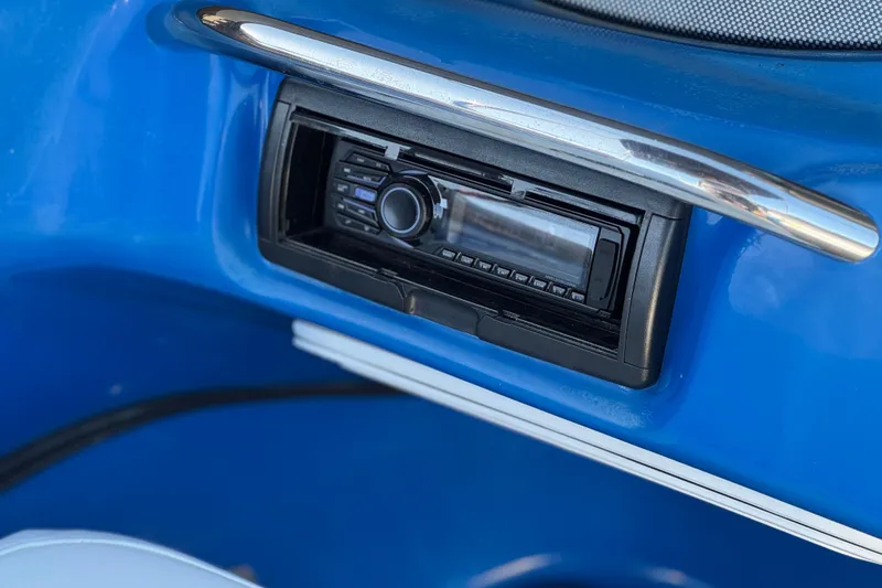 Slide: The Image of 2015 Caravelle 22 Interceptor boat stereo system in blue dashboard. - 21