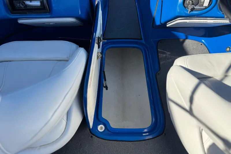 Slide: The Image of Interior of 2015 Caravelle 22 Interceptor boat with open storage compartment. - 22