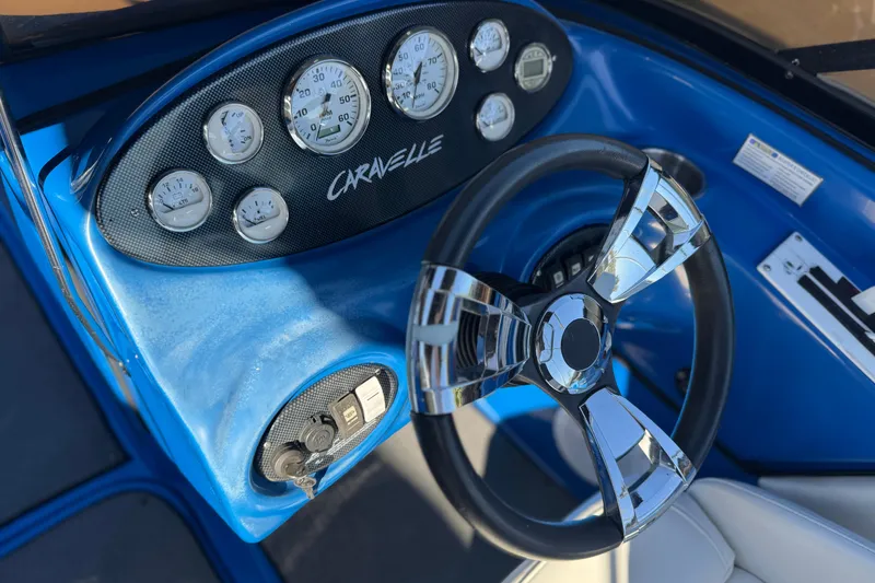 Slide: The Image of Dashboard of a 2015 Caravelle 22 Interceptor boat with chrome steering wheel. - 25