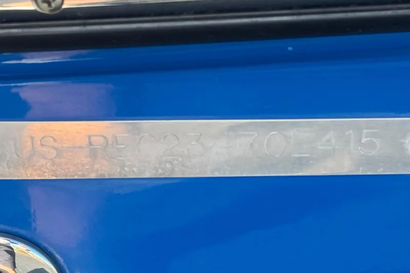 Slide: The Image of Close-up of a 2015 Caravelle 22 Interceptor's identification plate on a blue surface. - 29