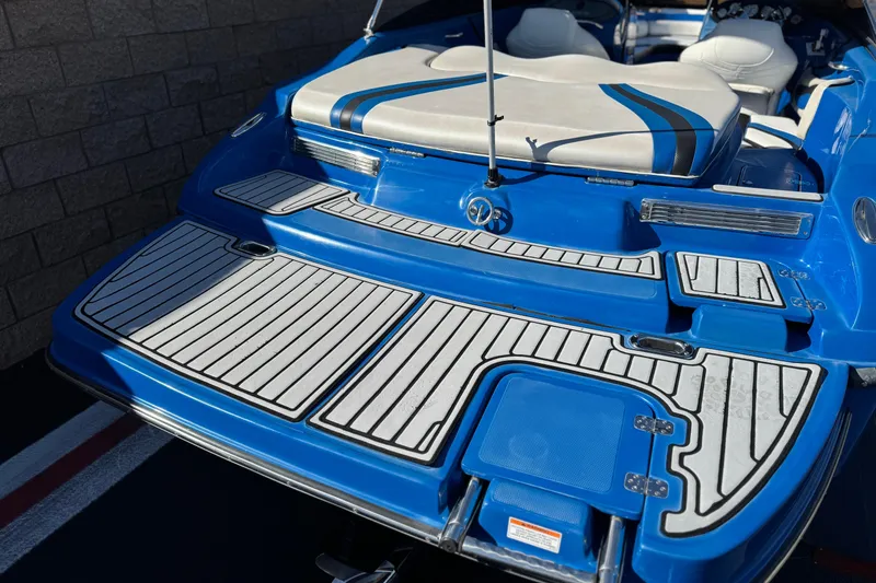 Slide: The Image of 2015 Caravelle 22 Interceptor boat with blue and white deck design. - 6