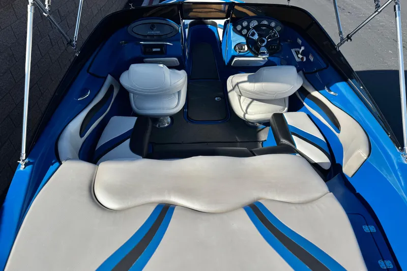 Slide: The Image of 2015 Caravelle 22 Interceptor boat interior with blue and white seating and dashboard. - 9