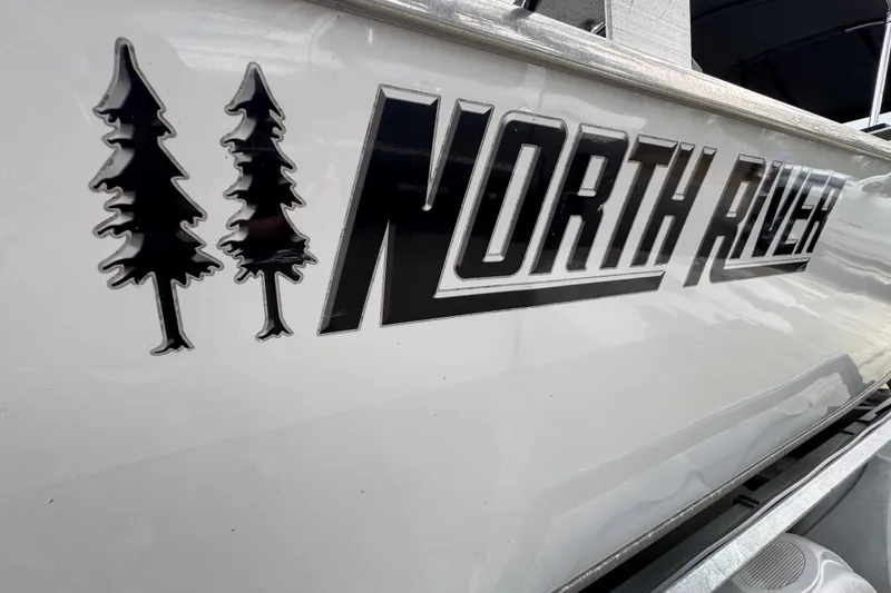 Slide: The Image of 2016 North River 21' Seahawk boat logo with tree graphics on the side. - 17